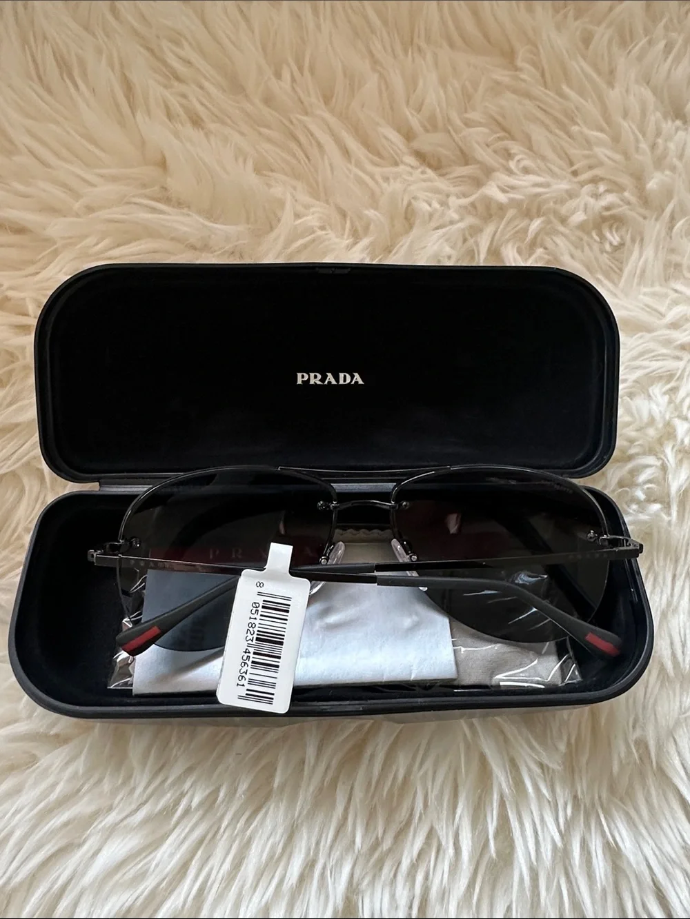 Prada Men’s Black and Silver Rimless Sunglasses